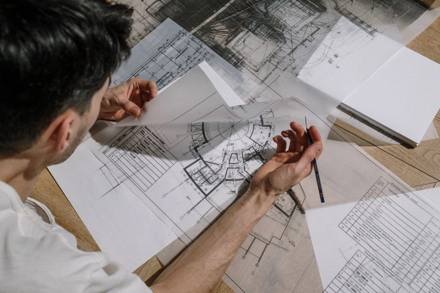 Architect sketching a floor plan — illustrative context