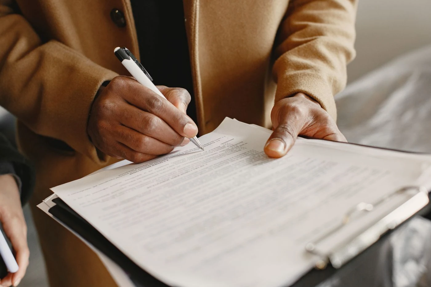 A Person Writing on White Paper while Holding a Pen · Free Stock Photo — illustrative context