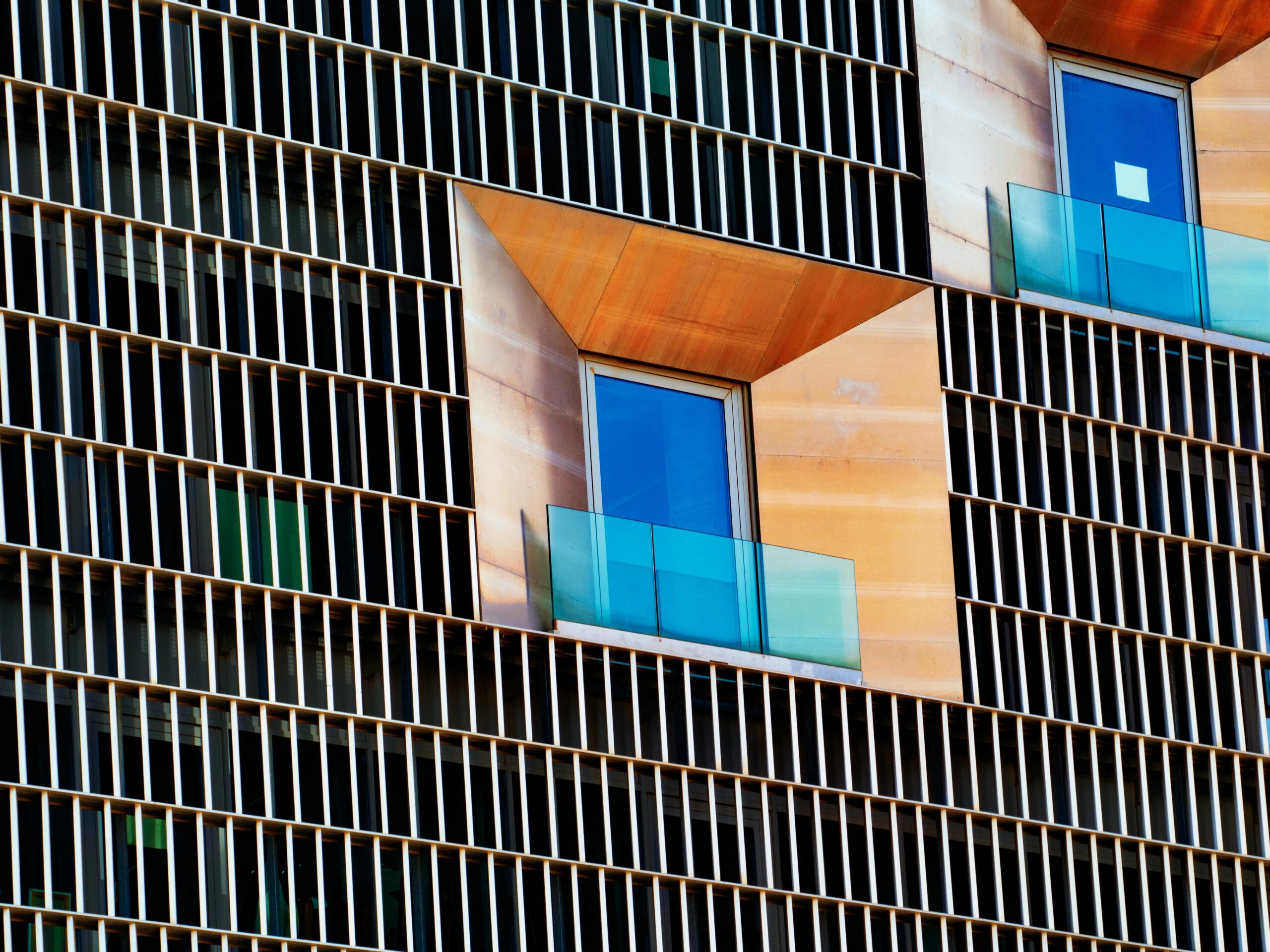 Close-up of modern building facade with unique window designs in Zaragoza, Spain.
