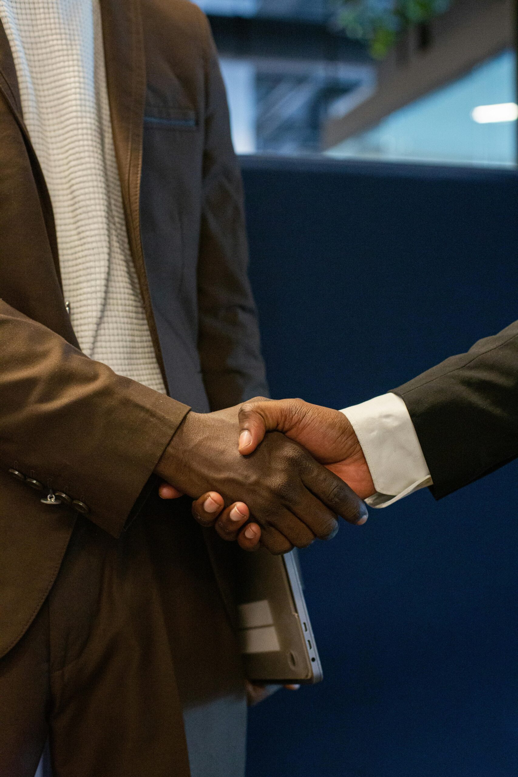 Close-up of two business professionals shaking hands, symbolizing a successful partnership.